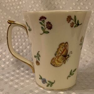 Skye McGhie porcelain mug featuring flowers, a dragonfly and a butterfly.